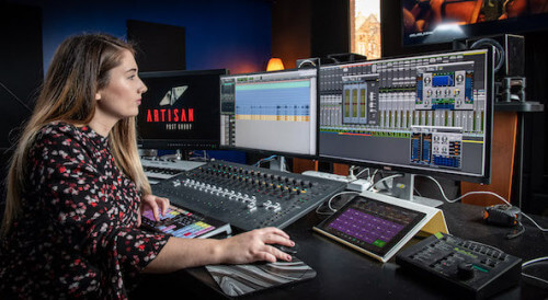Woman working on sound editing equipment