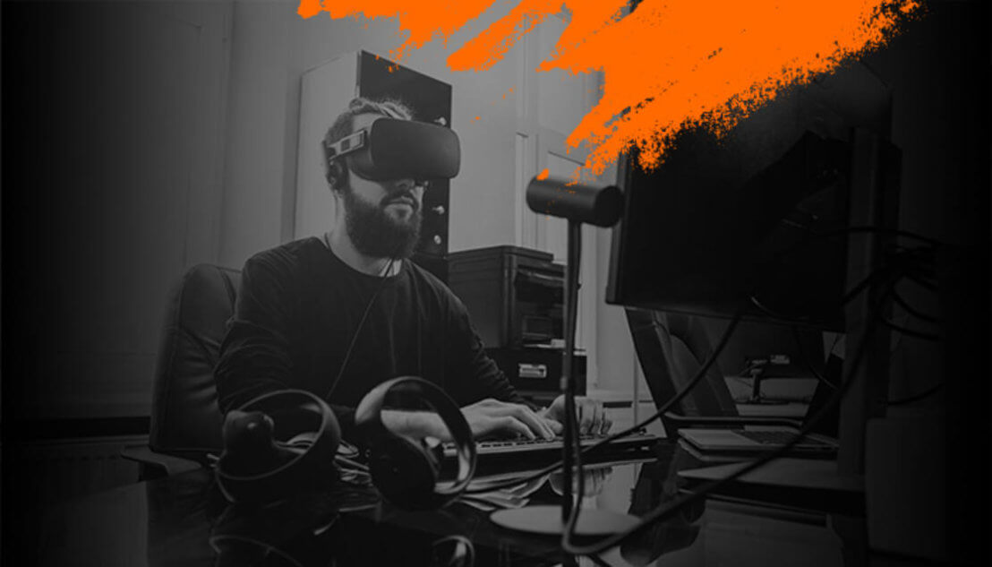 Black and white image of man with VR headset with orange splash on top