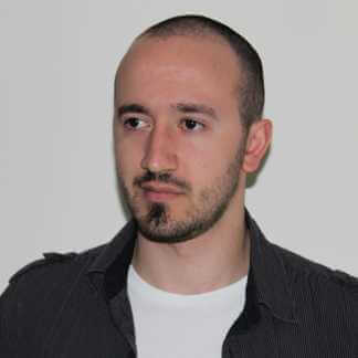 Andrew Kite. Man in a white and black shirt. Portrait head shot