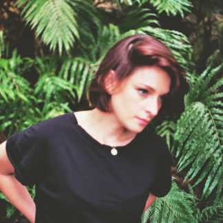 Woman standing in front of ferns