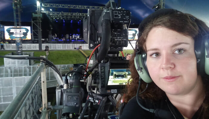 Woman behind the camera, filming a live show