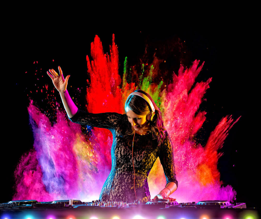 DJ performing with paint splashes in the background