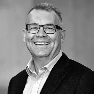 JOSEPH ANTHONYSZ. Corporate image of man wearing a dark suit, collared shirt and tie.