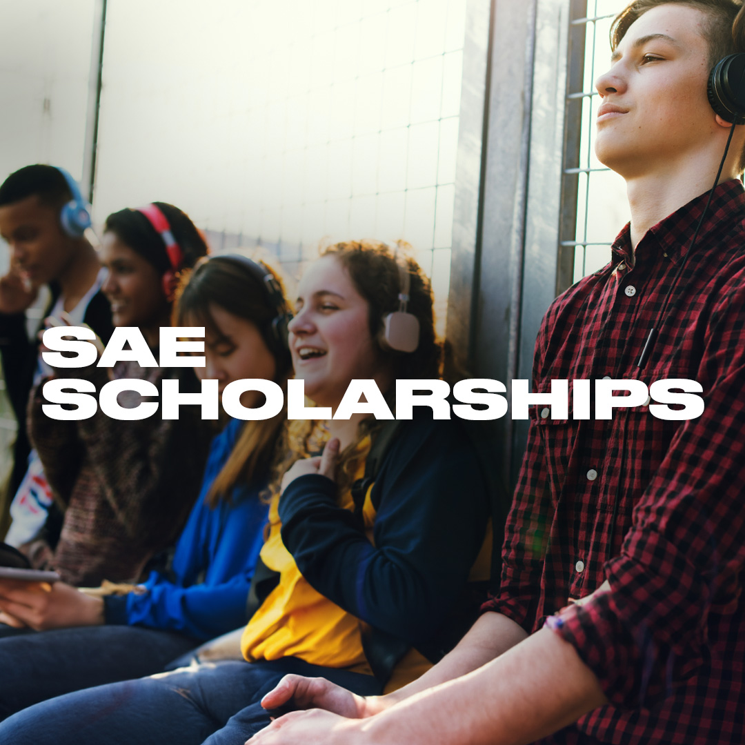 Text reads: SAE Scholarships. A young man wearing over-ear headphones, with four other students in the background.