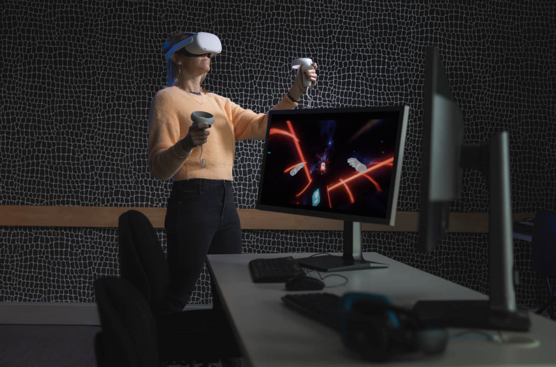 Person wearing VR headset and hand controllers