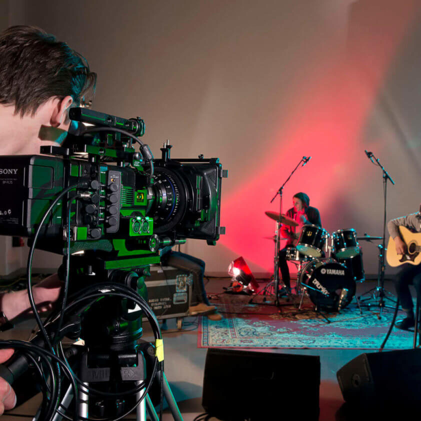 Film student filming musicians