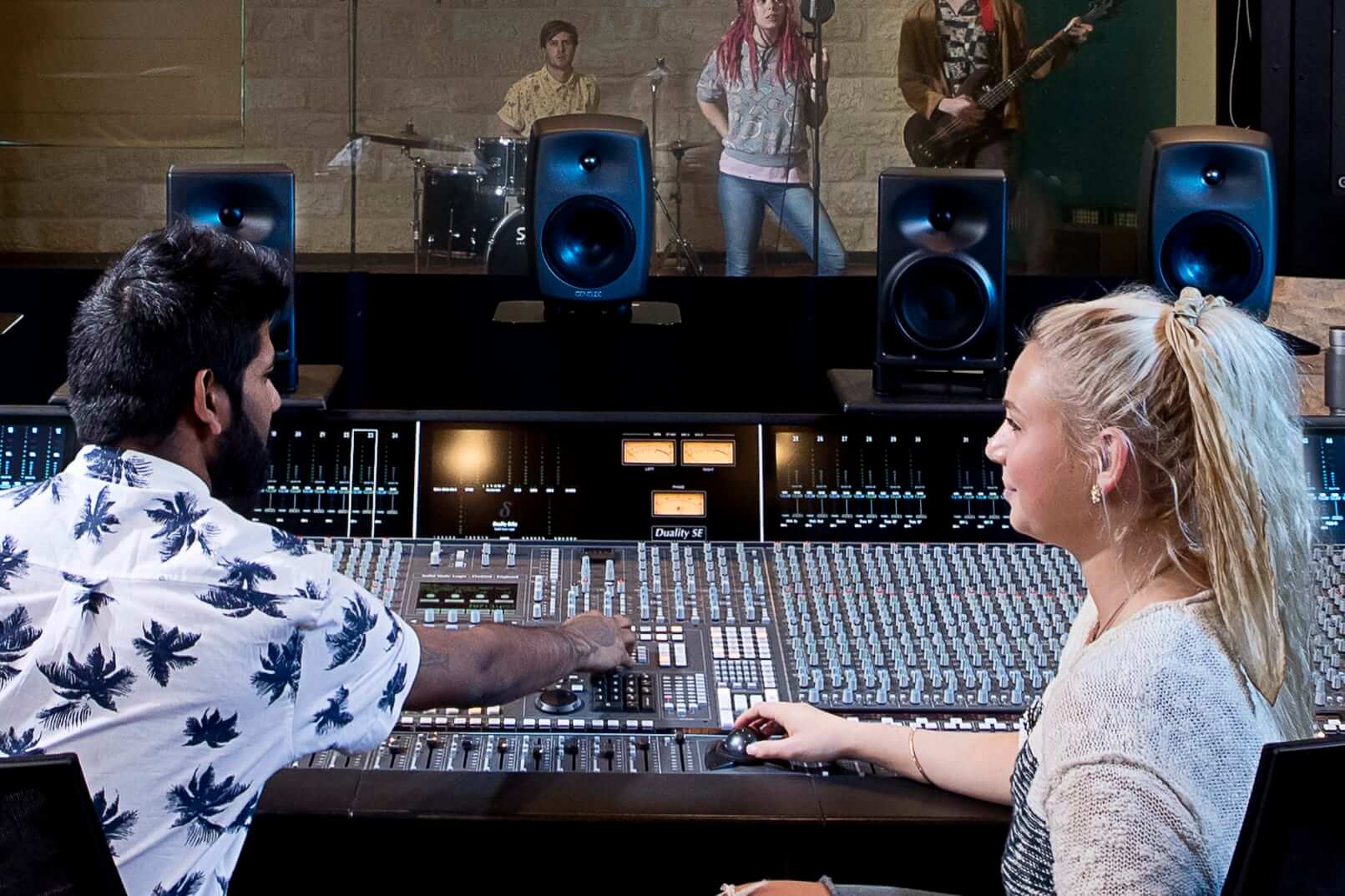 Two students working in a recording studio.
