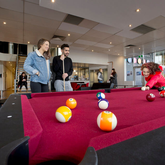 Students playing pool. SAE Melbourne student common area