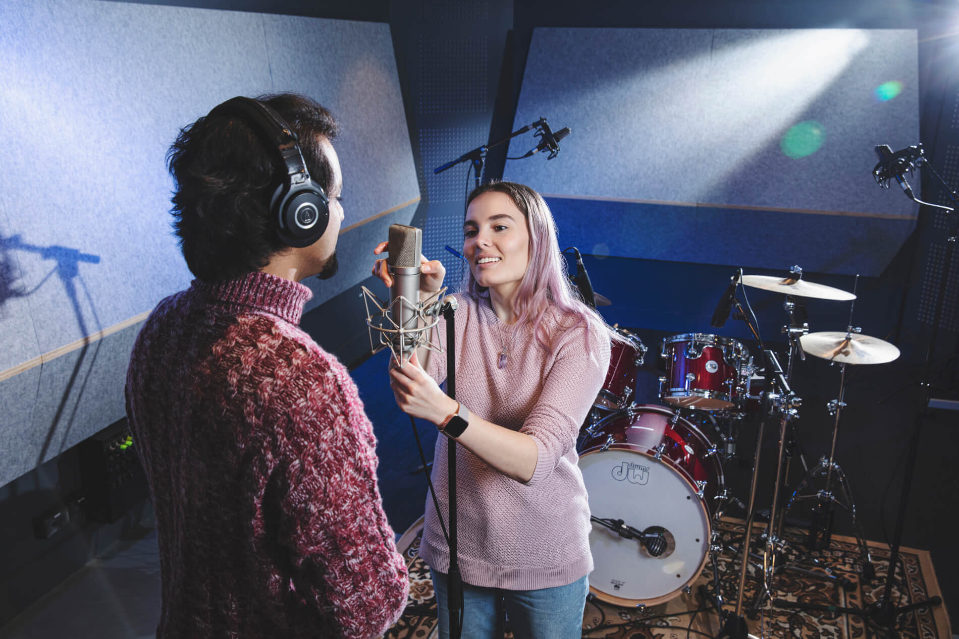 Student adjusting a Microphone in Audio Studio