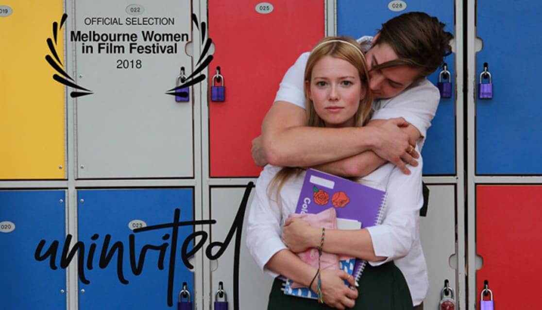 Movie poster. Woman with stright face being hugged by man from behind. Text reads: Uninvited. Official Selection Melbourne Women in Film Festival 2018.
