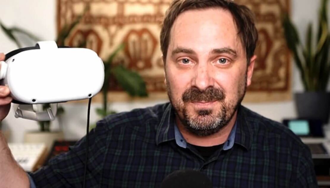 Man holding a VR headset in his hand