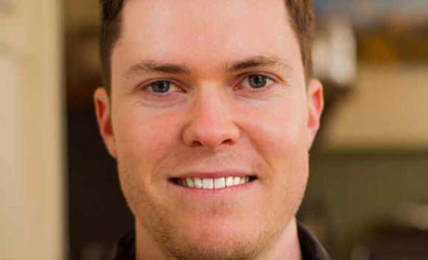 Man smiles at camera.