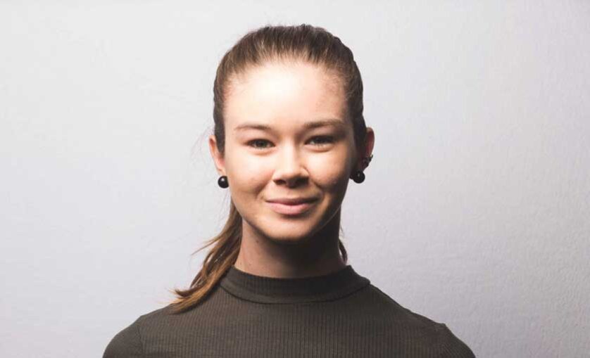 SAE Alumni graduate Evie Slattery smiles to camera