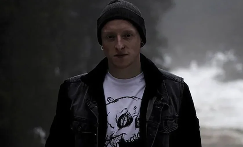 Man wears a beanie and leather jacker. Graduate and SAE Alumni Jair Wallace