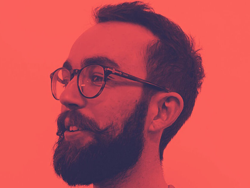Portrait of man with glasses and beard. Orange hue on photo