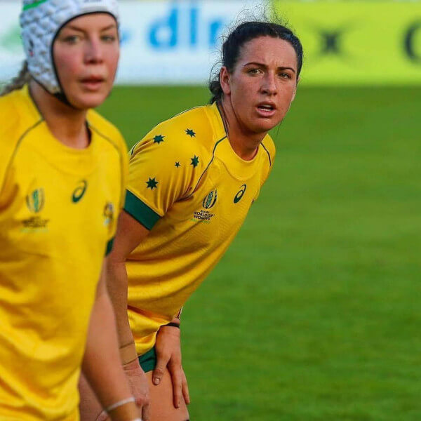 Female rugby players on the field.