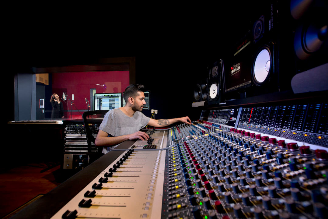 Male student working on a Neve Audio desk