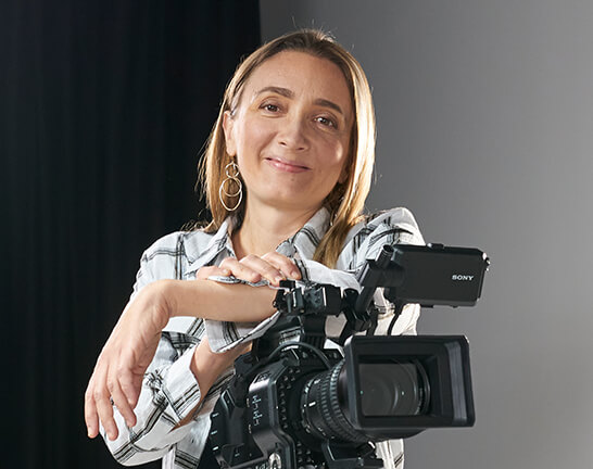 SAE Staff member posing with Sony film camera