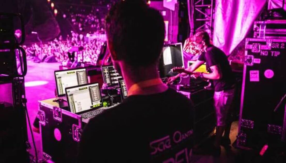 Students playing a gig with purple lights
