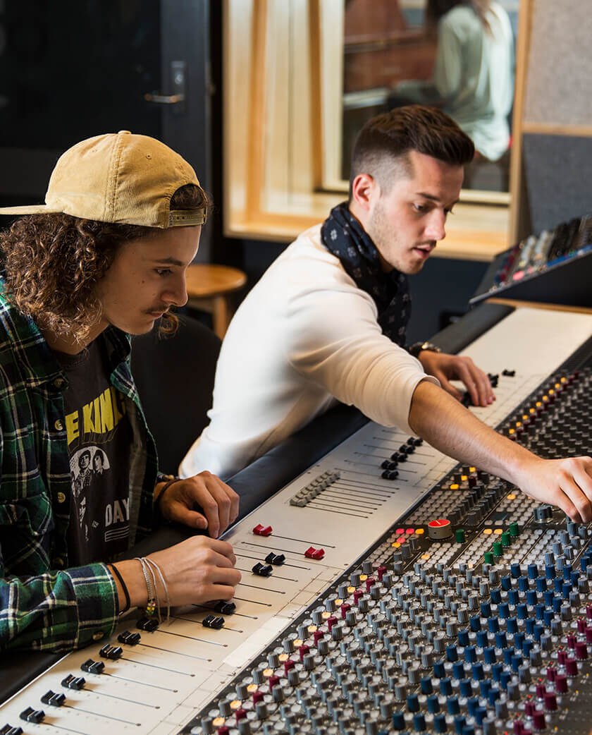 Two students operating an audio desk