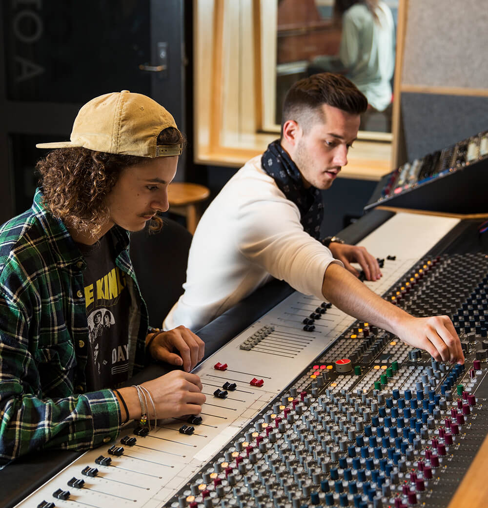 Two students operating an audio desk