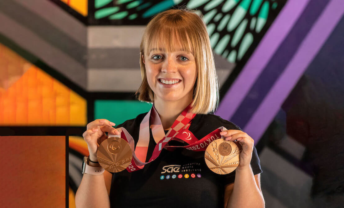 Woman posing with Olympic medals