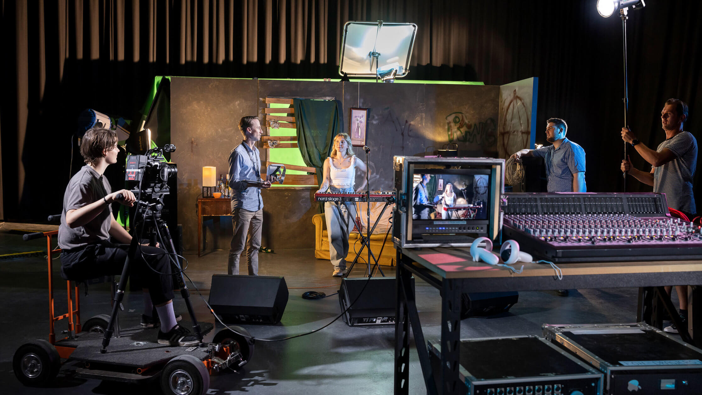 A group of creative practitioners in film, music, audio, sound, directing and project managing on a film set.