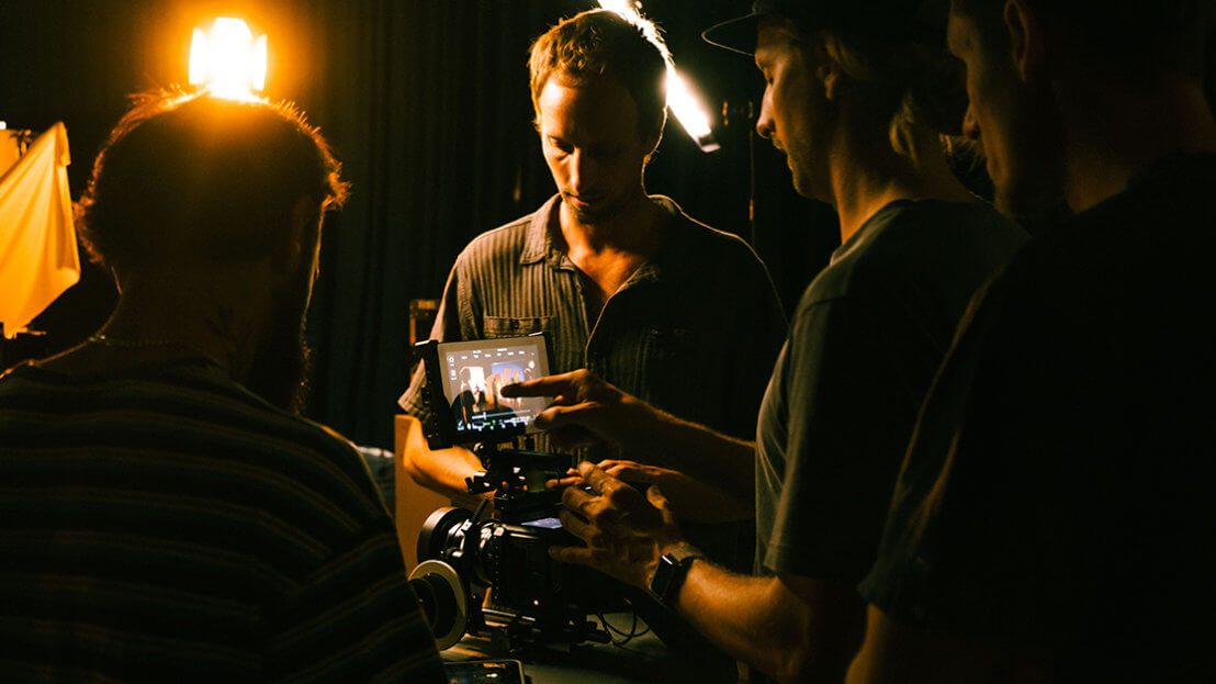 Film students looking at footage on a monitor of a camera