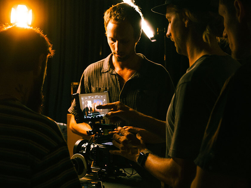 Film students looking at footage on a monitor of a camera