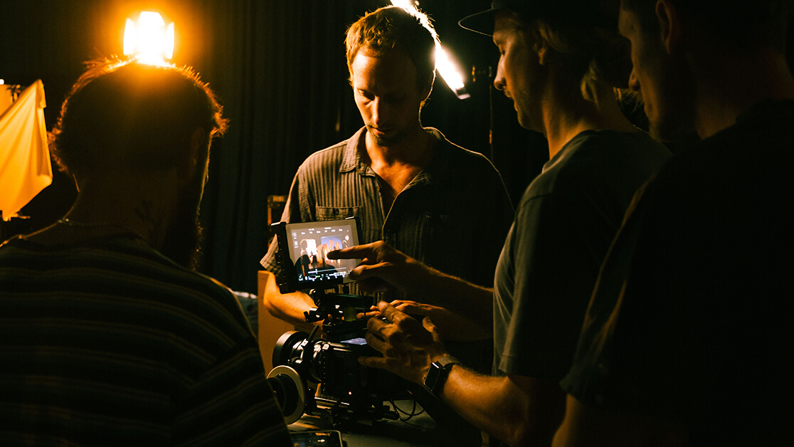 Film students looking at footage on a camera