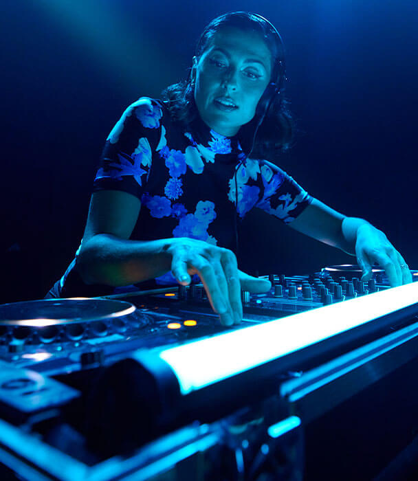 DJ Anna Lunoe mixing music at audio mixing console