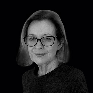 Woman wearing glasses and black shirt. Corporate headshot. Dr Barbara Adkins