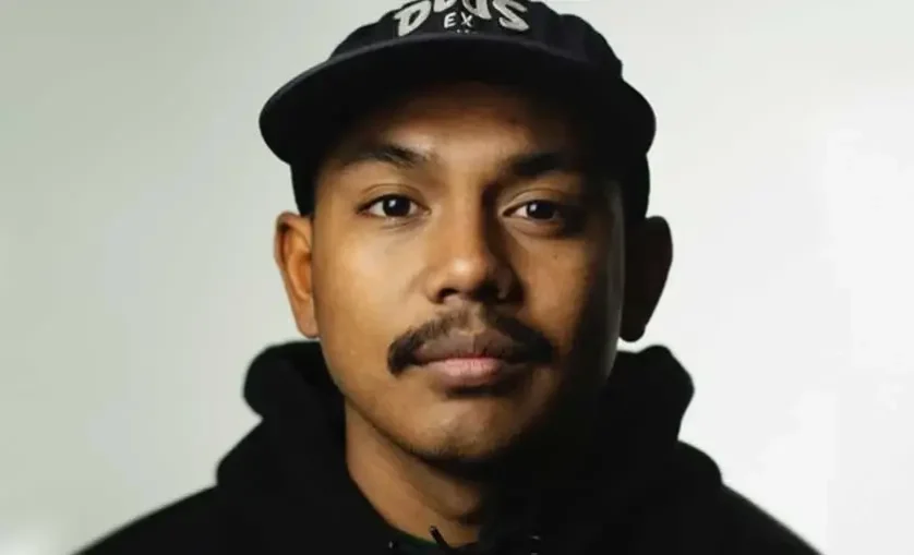 Man wearing a black hat and black hoodie