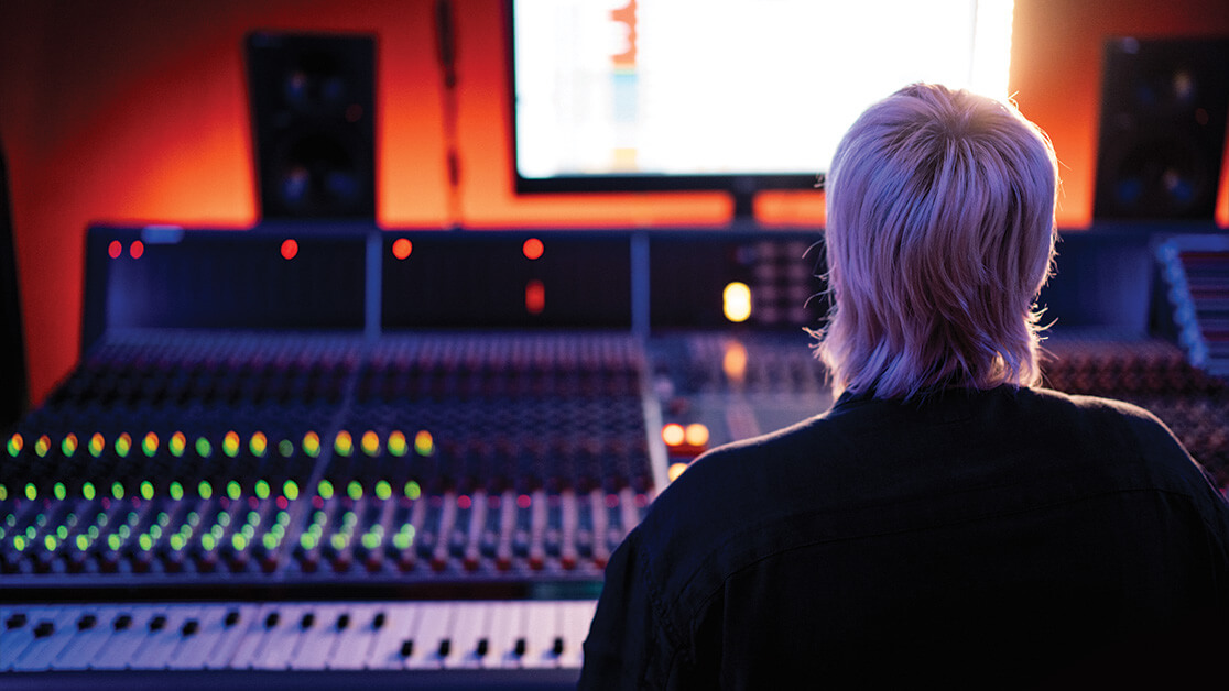 Girl sits at audio console