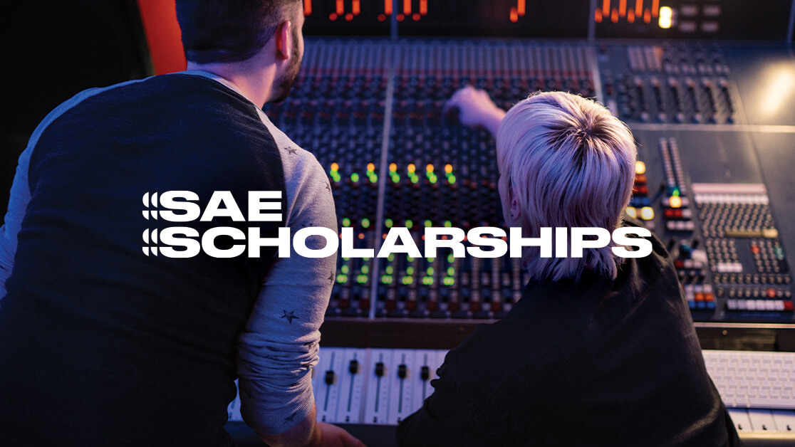 Two people in an audio studio, pointing as they stand over console. Text: SAE Scholarships