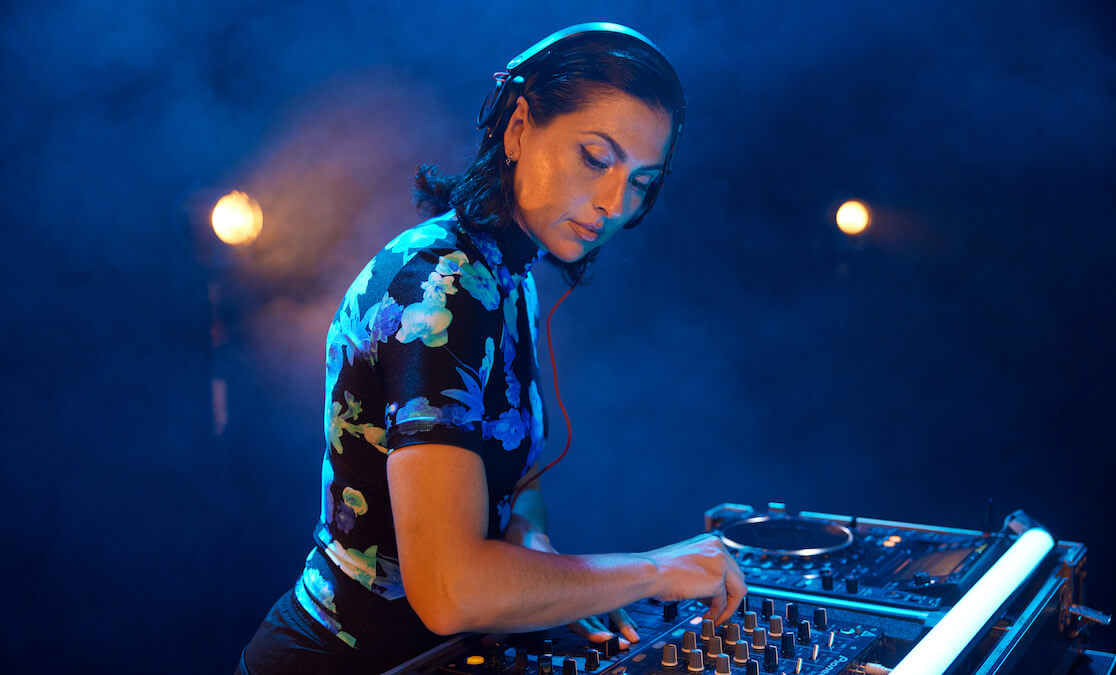 Female DJ mixing music in club