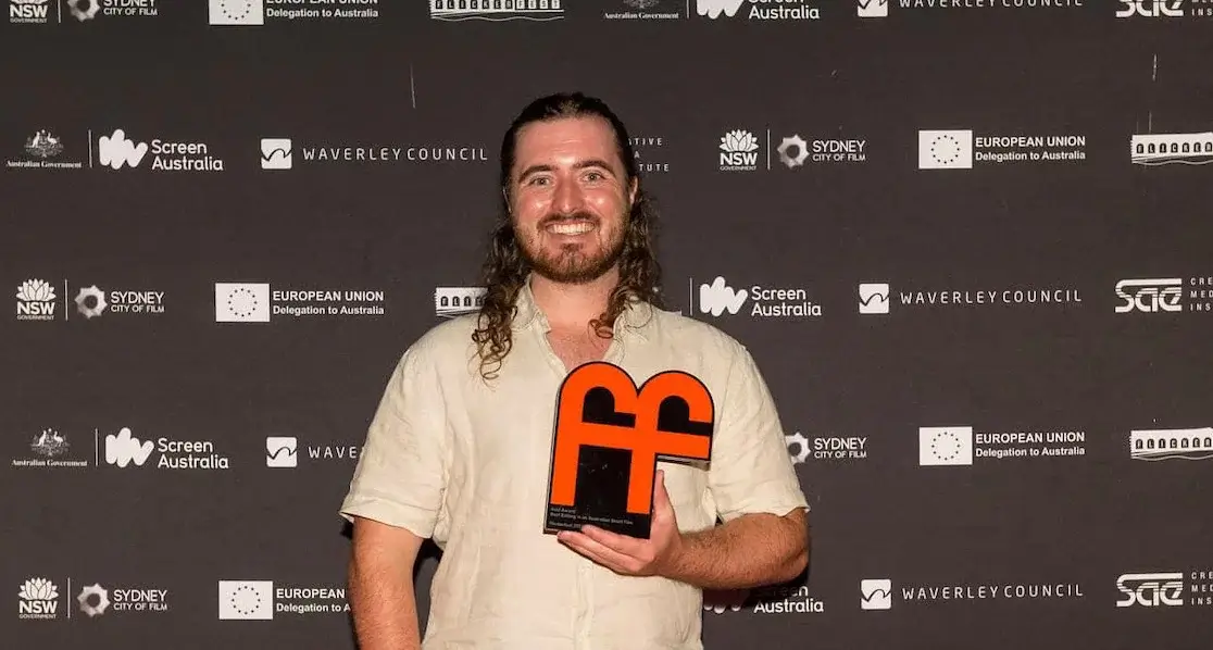 Cameron Drew holding his Flickerfest award