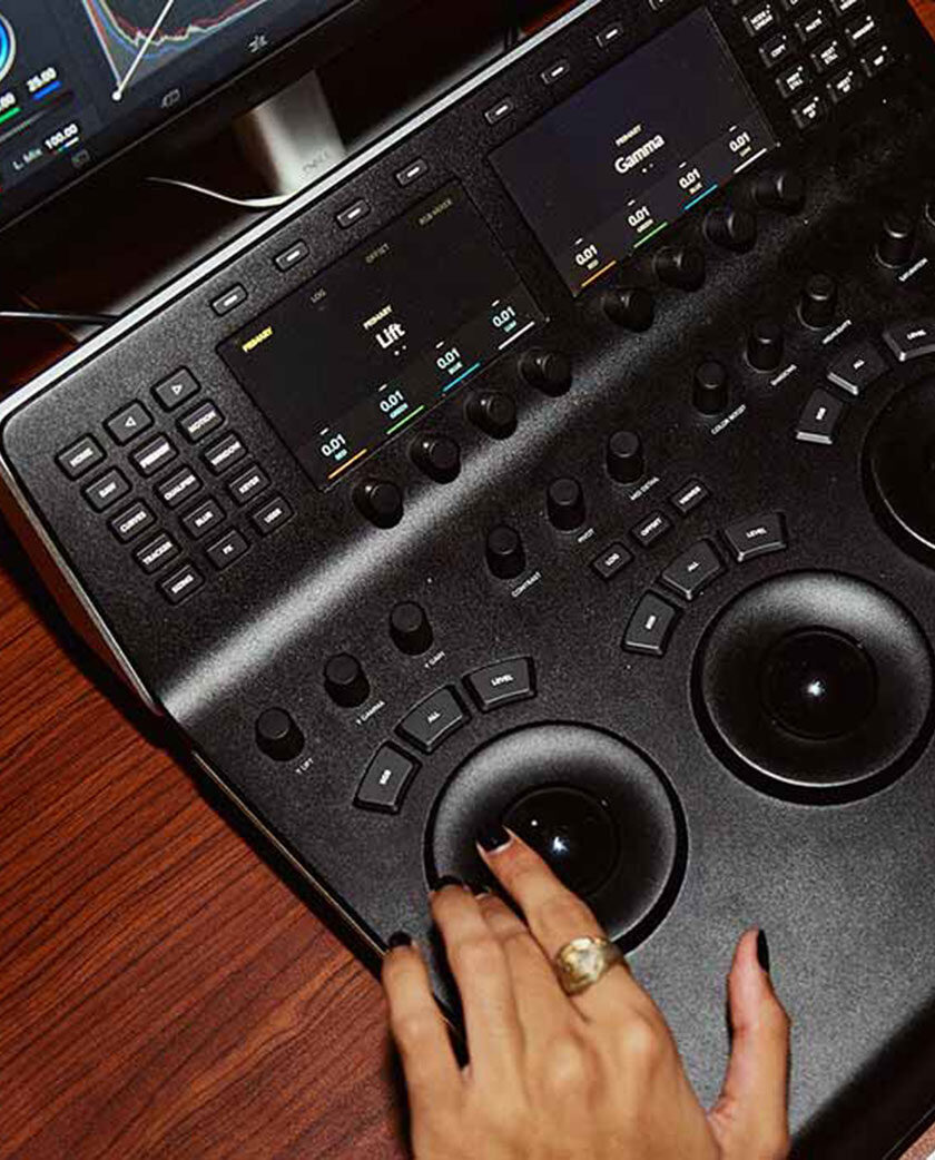A hand at a desk operating a graphics tablet