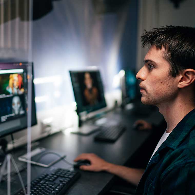 Man looks at computer screen monitor.