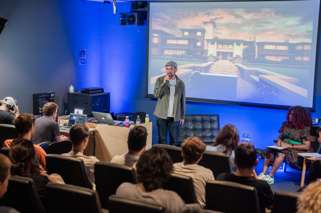 Man speak in front of auditorium of people