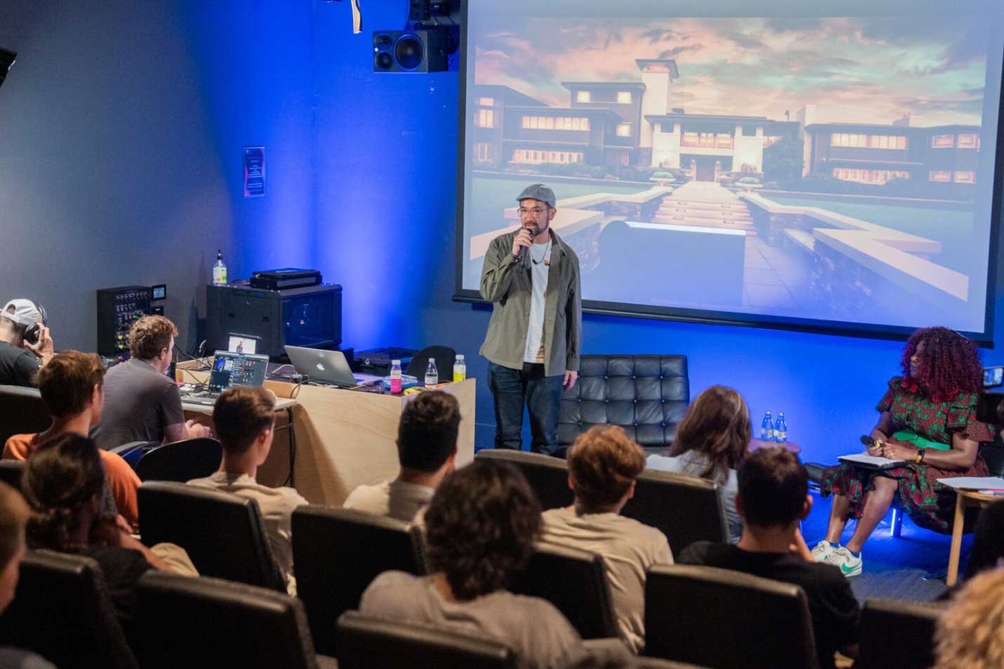 Man speak in front of auditorium of people