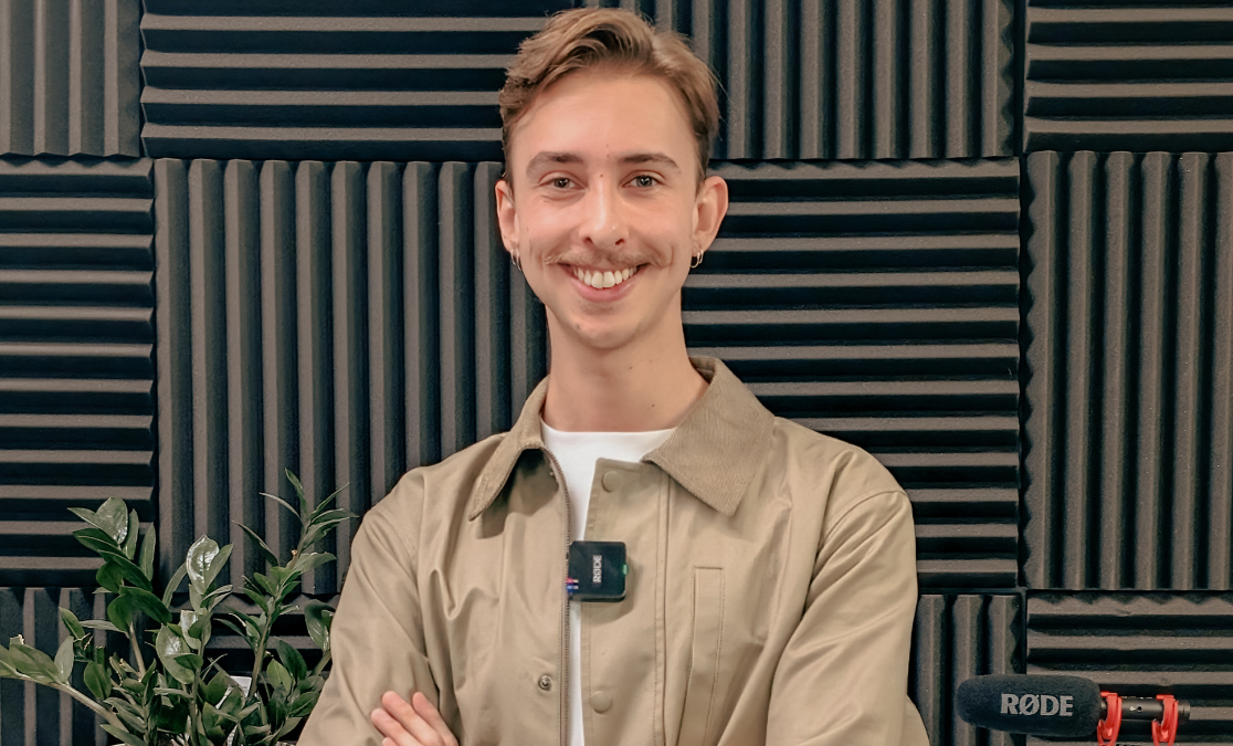 Young man with moustache wearing portable microphone