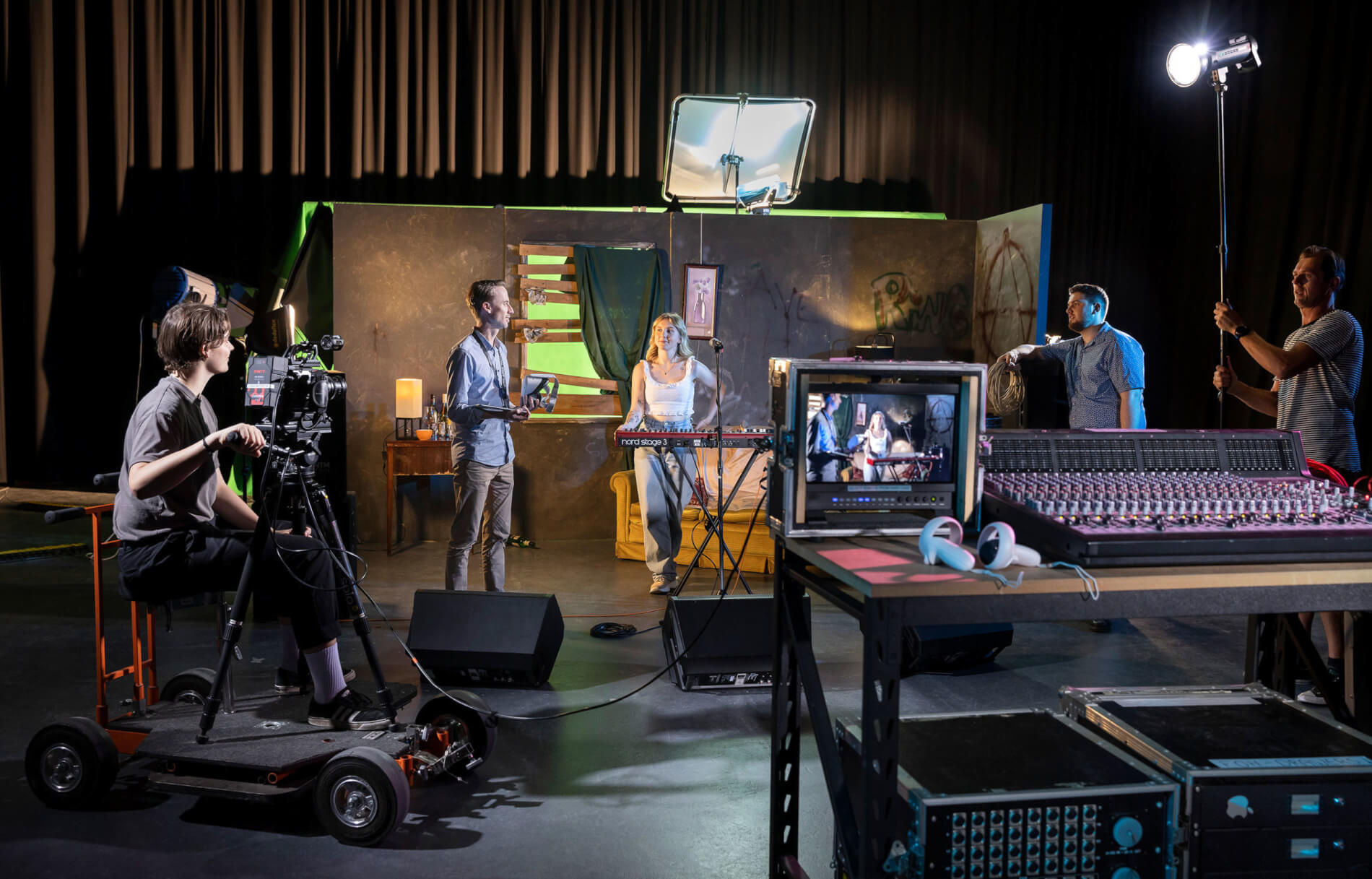 A group of creative practitioners in film, music, audio, sound, directing and project managing on a film set.