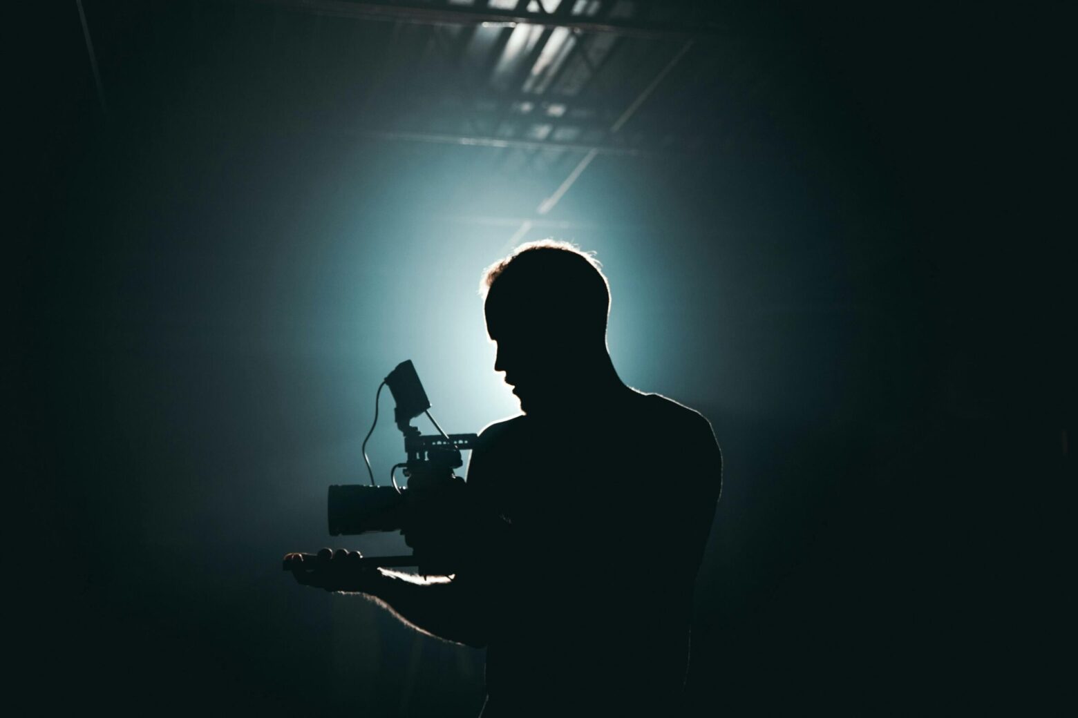 Silhouette of man with professional camera