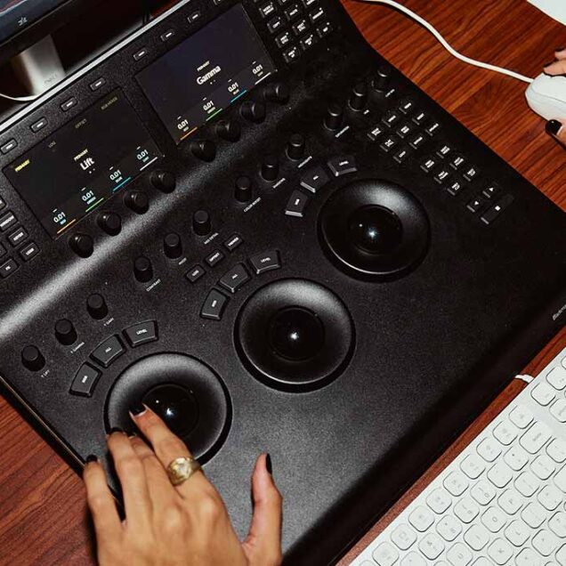 Two hands at a desk operating a graphics tablet