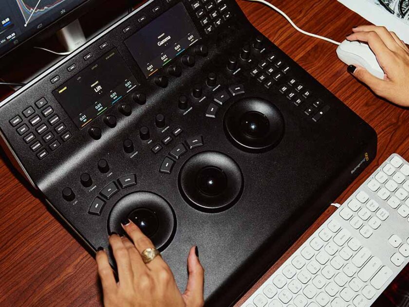Two hands at a desk operating a graphics tablet