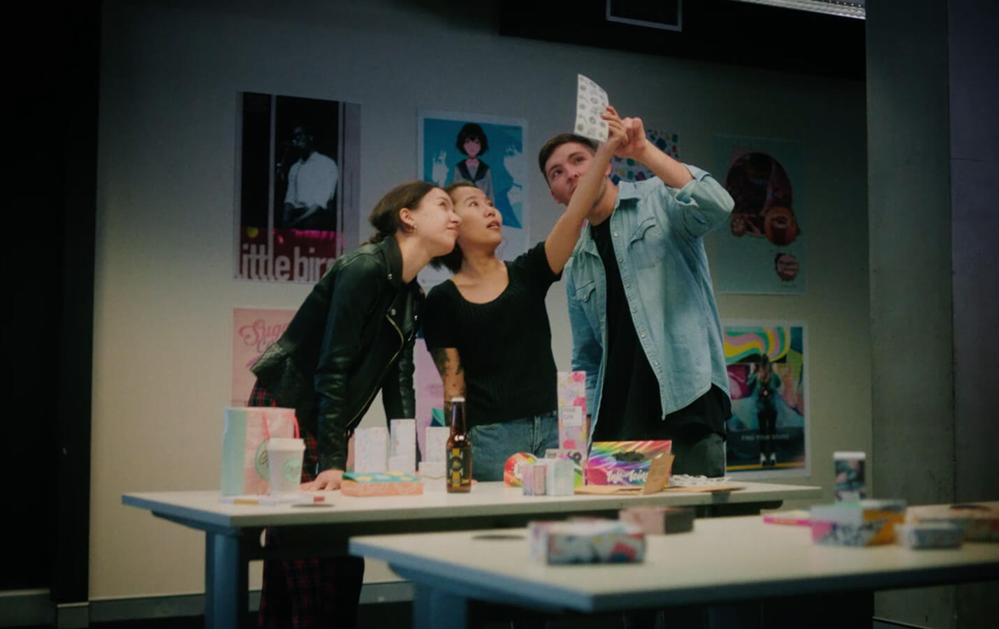 Three students looking at a design