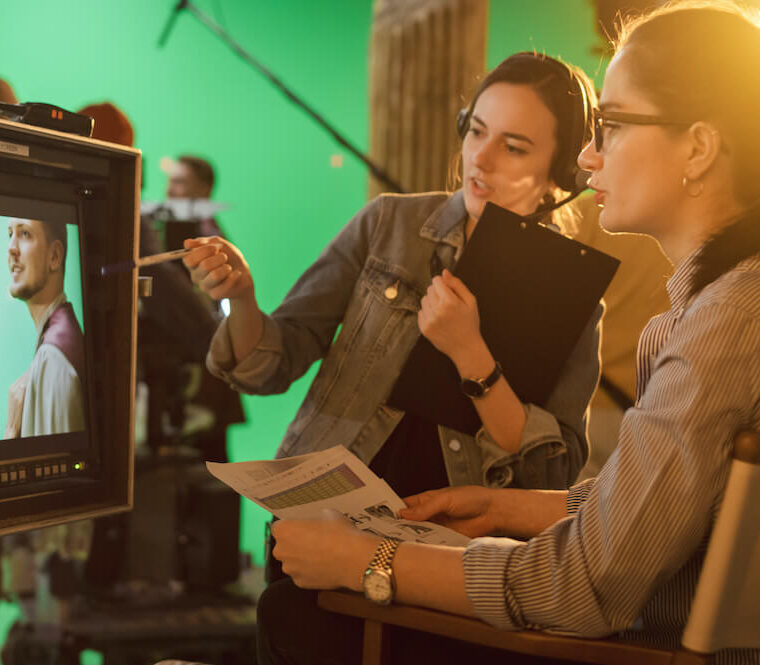 Director and producer reviewing footage