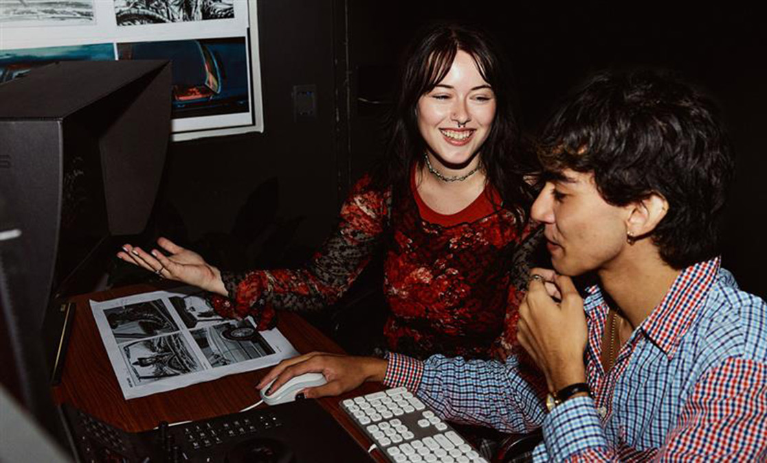 A male and female student working together on a desktop computer (1116x675)