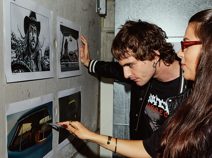 A male and female student looking at still images posted on a wall - SAE Open House event Brisbane (1116x628)